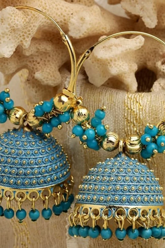 Handcrafted royal blue and gold Meenakari Jhumka earrings with bead tassels on a neutral coral background - Panachemode Sydney.