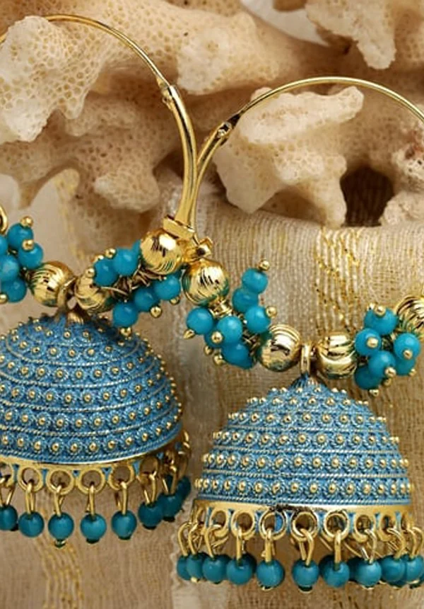 Handcrafted royal blue and gold Meenakari Jhumka earrings with bead tassels on a neutral coral background - Panachemode Sydney.