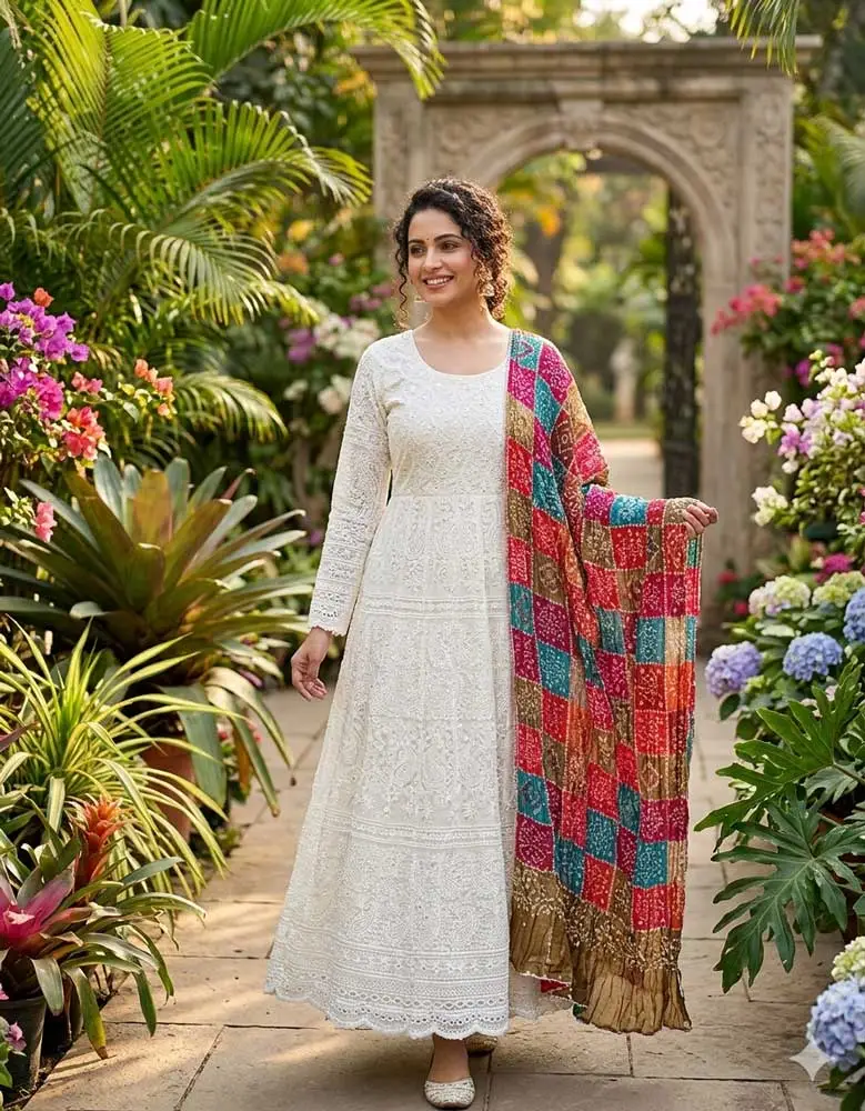 Model in a garden wearing a white embroidered Chikankari Anarkali suit with a colorful checkered Bandhani dupatta – Panachemode Australia.