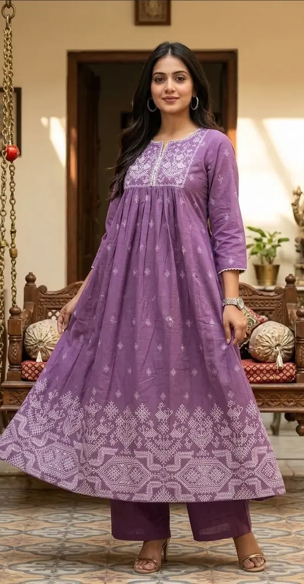 Woman wearing a lavender A-line cotton kurta with white embroidery on the neck and border, paired with matching palazzo pants.