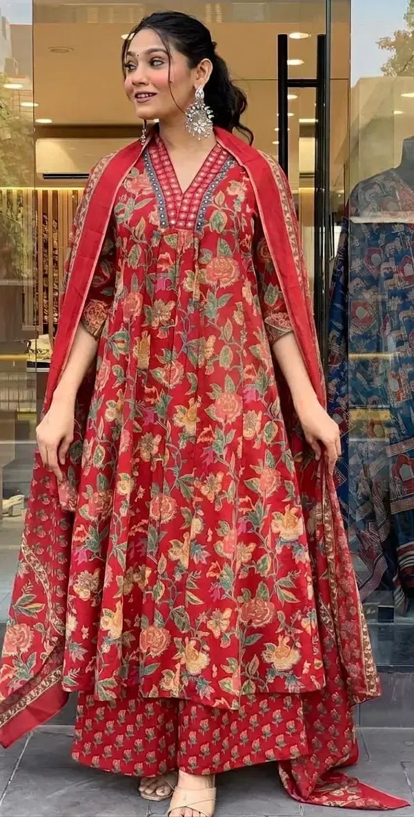 Woman wearing a red floral print A-line cotton kurti with matching palazzo pants and dupatta featuring handwork on the neckline.